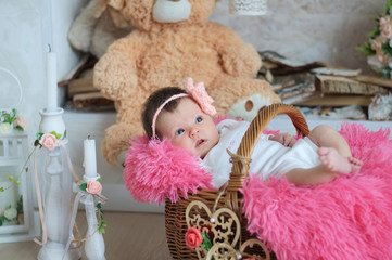 newborn baby girl in pink blanket lying in basket, cute card composition