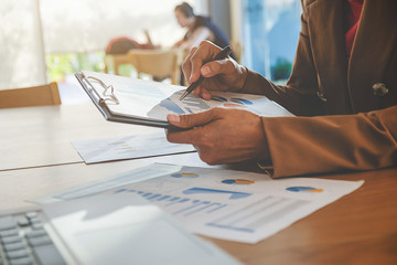 Business concept. Business people discussing the charts and graphs showing the results of their successful teamwork.