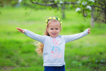 Portrait of happy little girl on a summer park