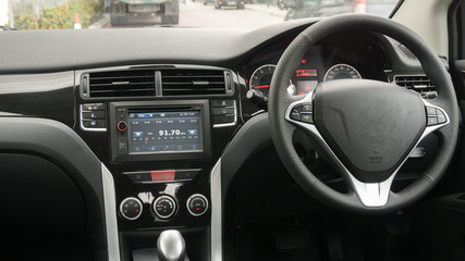 Driver's seat in the car with a white interior