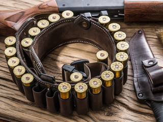 Pump action shotgun, 12 guage cartridge  and hunting knife.