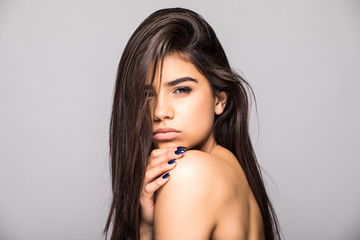Naklejka premium Beautiful smiling girl with clean skin, natural make-up on grey background