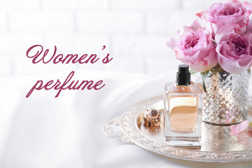 Women's perfume. Tray with bottle of scent on dressing table