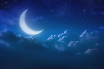 Naklejka na ściany i meble half blue moon behind cloudy on sky and star at night. Outdoors at night. lunar shine moonlight over cloud at nighttime with copy space background for headline text and graphic design.