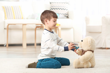 Cute little boy playing with inhaler at home. Allergy concept