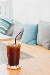 Ice coffee drink on wooden table in coffee shop cafe background