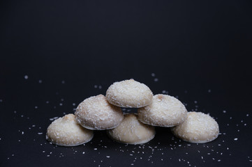 Cookies with cocos. Biscuits with cocos. Biscuits with white chocolate and cocos on black...