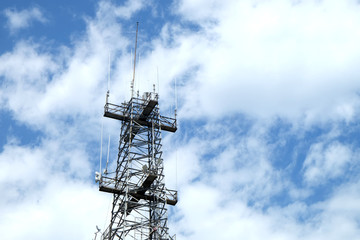 Big antenna towers for radio signal broadcasting in clear blue sky
