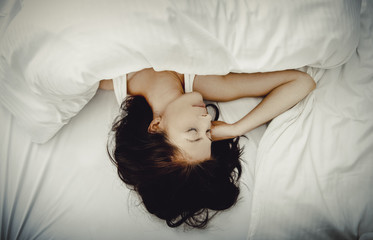 Fototapeta na wymiar Woman sleeping in bed.