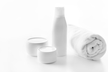 Obraz na płótnie Canvas different skin cream or body lotion and towel isolated on white