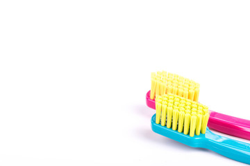 Close up of pink and blue toothbrushes isolated on white background