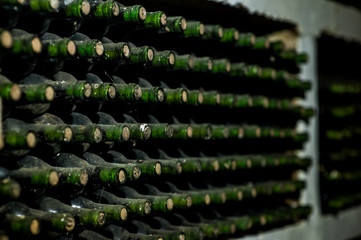 Old wine bottles in a cobweb in the cellar