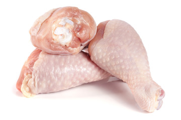 Three raw chicken drumsticks isolated on white background