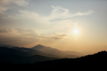 Evening fog covers lonely mountains