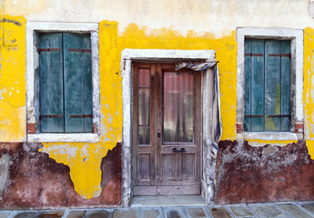 old door and windows on aged wall