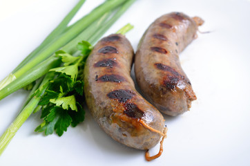 Grilled homemade liver sausage on white plate