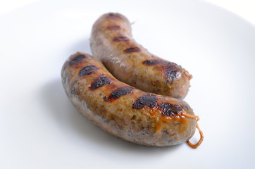 Grilled homemade liver sausages on white plate