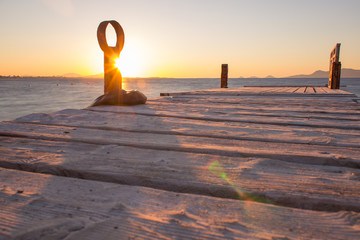 Sunset at a dock at the ocean