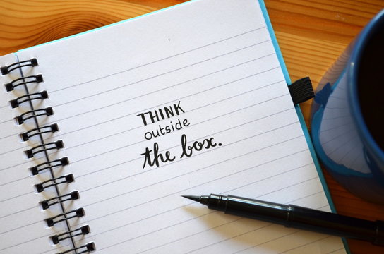 THINK OUTSIDE THE BOX written in notebook