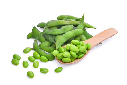 edamame beans in wooden spoon isolated on white background