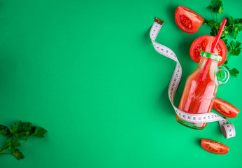 Tomato juice on green background. Healthy eating concept