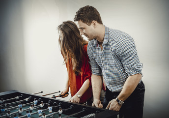 Friends playing table football.