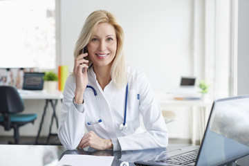 Female doctor discussing on mobile phone