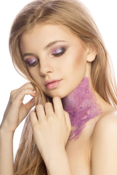 Lovely woman face with bright makeup and glitter on her neck on white background