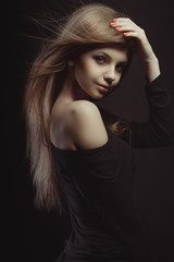 Fototapeta premium Attractive young woman with glitter on her neck and wind blowing her hair