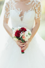 The beautiful bride keeps a luxury bouquet