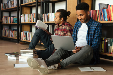 Young two african men students sitting in library