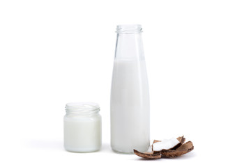 Fototapeta na wymiar organic coconut oil in glass jar and coconut milk in glass bottle isolated on white, coconut drink concept