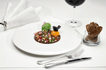 Veal tartar and wine in a restaurant