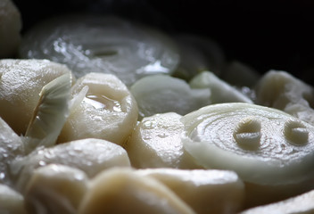 Frying process of potatoes wit fresh onions