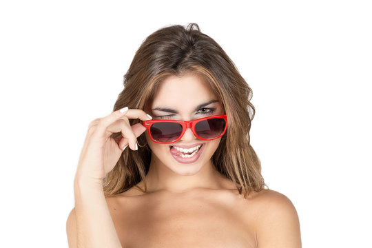 Beautiful young woman with blond hair and red sunglasses with funny face