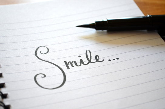 “Smile…” hand lettered in notebook