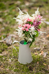Bouquet of daisy-chamomile flowers in concrete pot in the morning