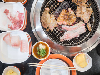 Streaky pork grilling on charcoal stove, Top view.