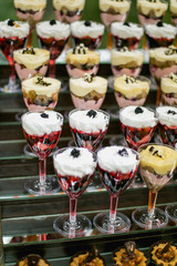 fruit jelly with berries in glasses on wooden table