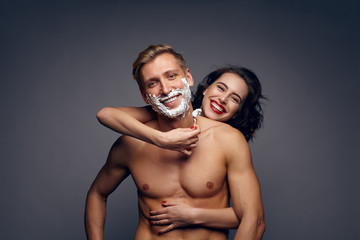 Couple embracing and shaving