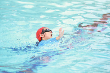 Fototapeta na wymiar Children boy in swimming pool