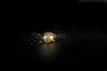 christmas ball ,filled with colored sugar, shot with an air rifle