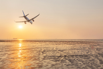 airplane flying at sunset