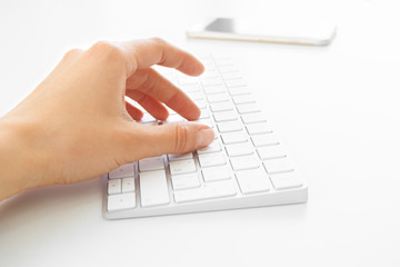 Woman's hands using keyboard at the office