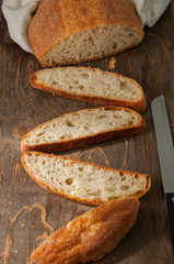 Freshly baked homemade bread on a wooden table. Top view.
