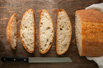 Freshly baked homemade bread on a wooden table. Top view.