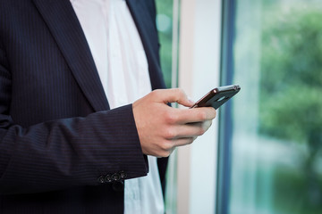 A businessman talking on a mobile phone,Businessman talking on the phone in office,Senior businessman,Portrait of businessman talking on mobile phone,business concept