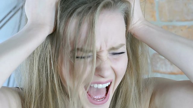 Angry girl pulling her hair because of some problems, steadycam shot
