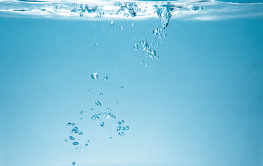 fresh fizzy water in the glass with bubbles background, close up view, health, diet nutrition