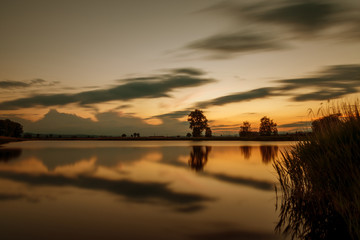 Fototapeta na wymiar Magnificent long exposure lake sunset